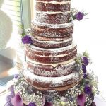 Chocolate naked cake with purple flowers